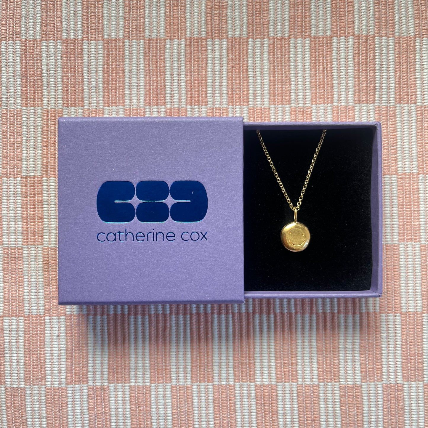 Gold plated smiley pendant